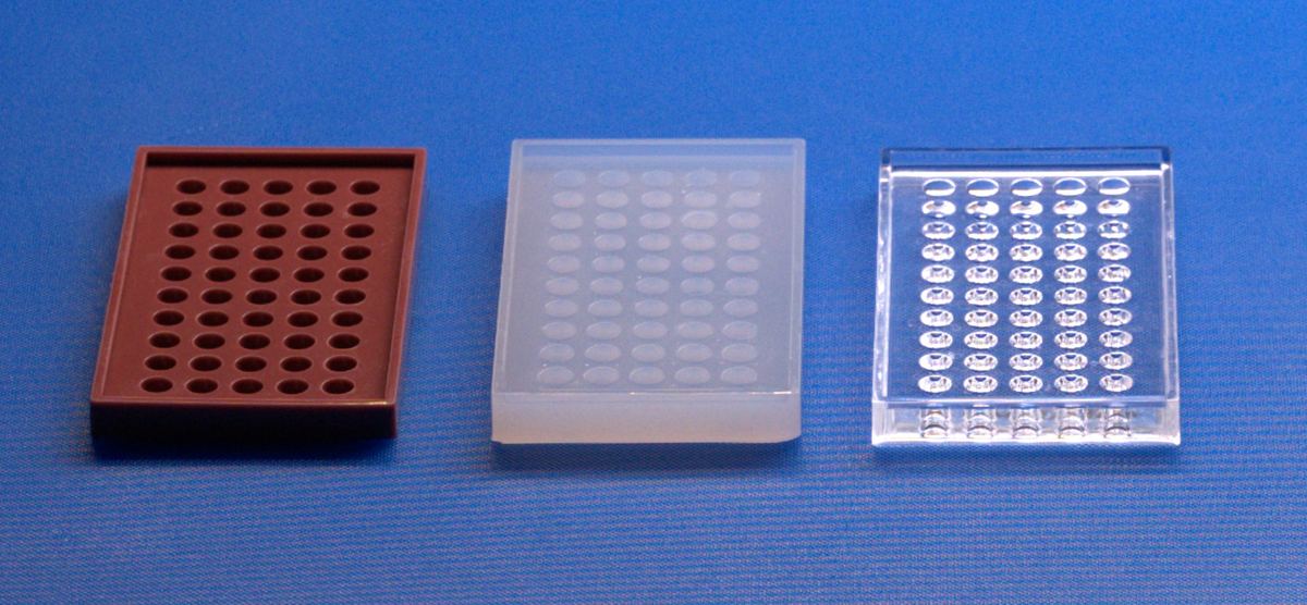 Three mold trays with oval-well cavities in different materials